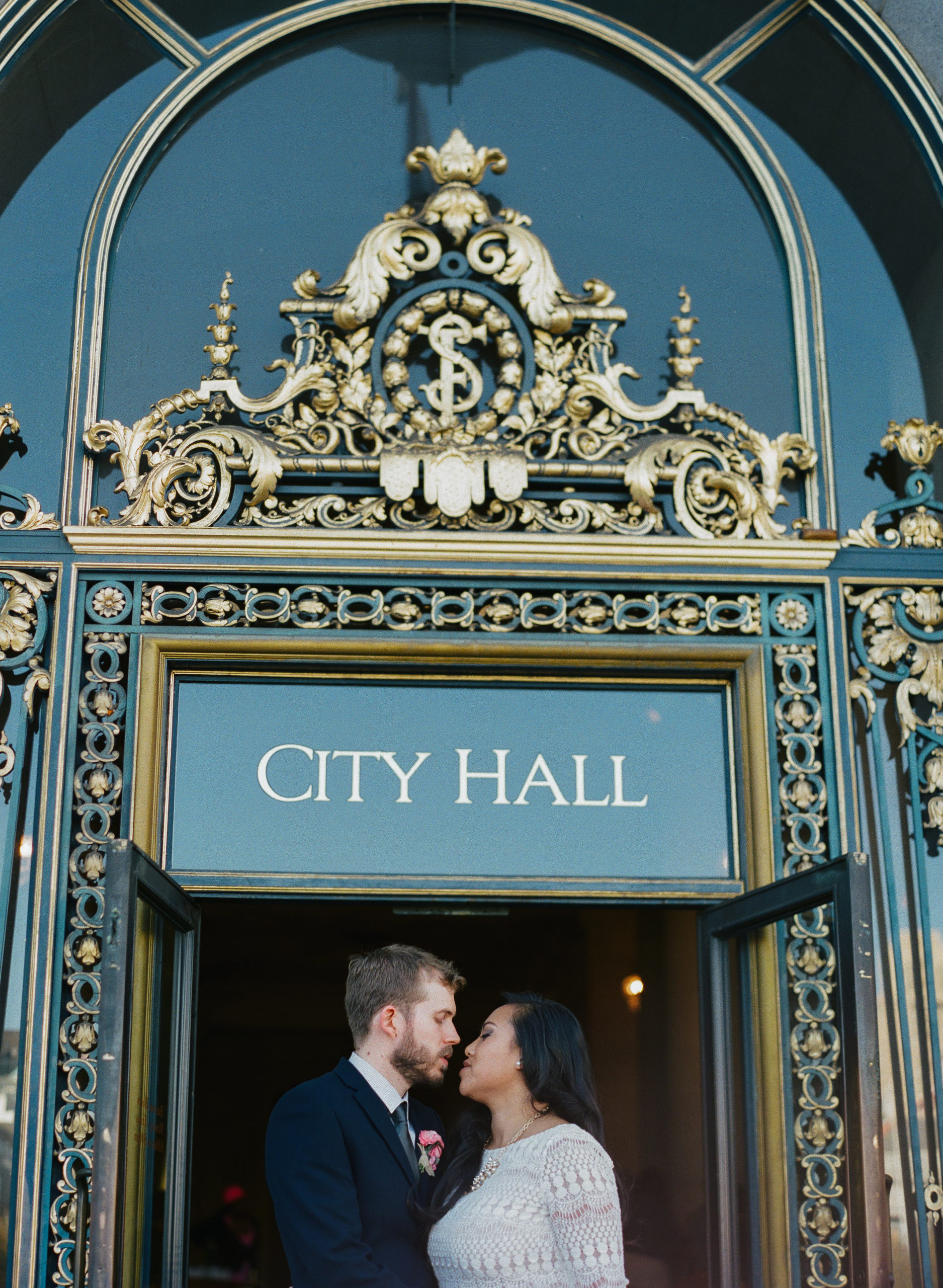 Bride and Groom Kiss in front of City Hall