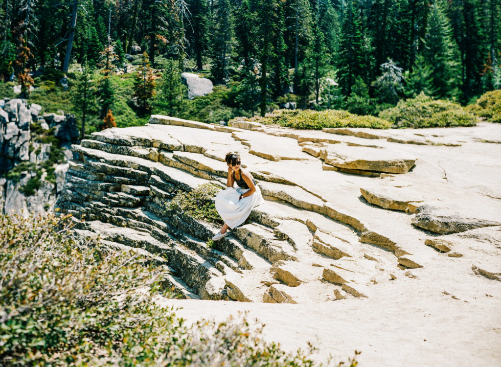 Girl sits on a Taft Point Yosemite Fissure