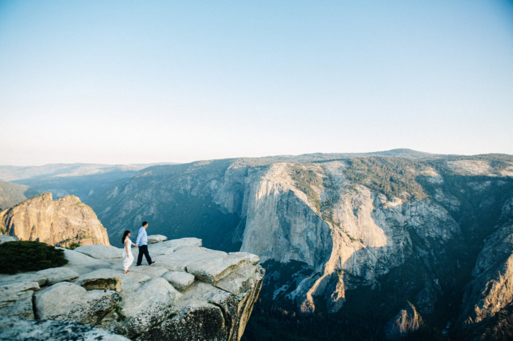 Couple walking on a cliff in yosemite